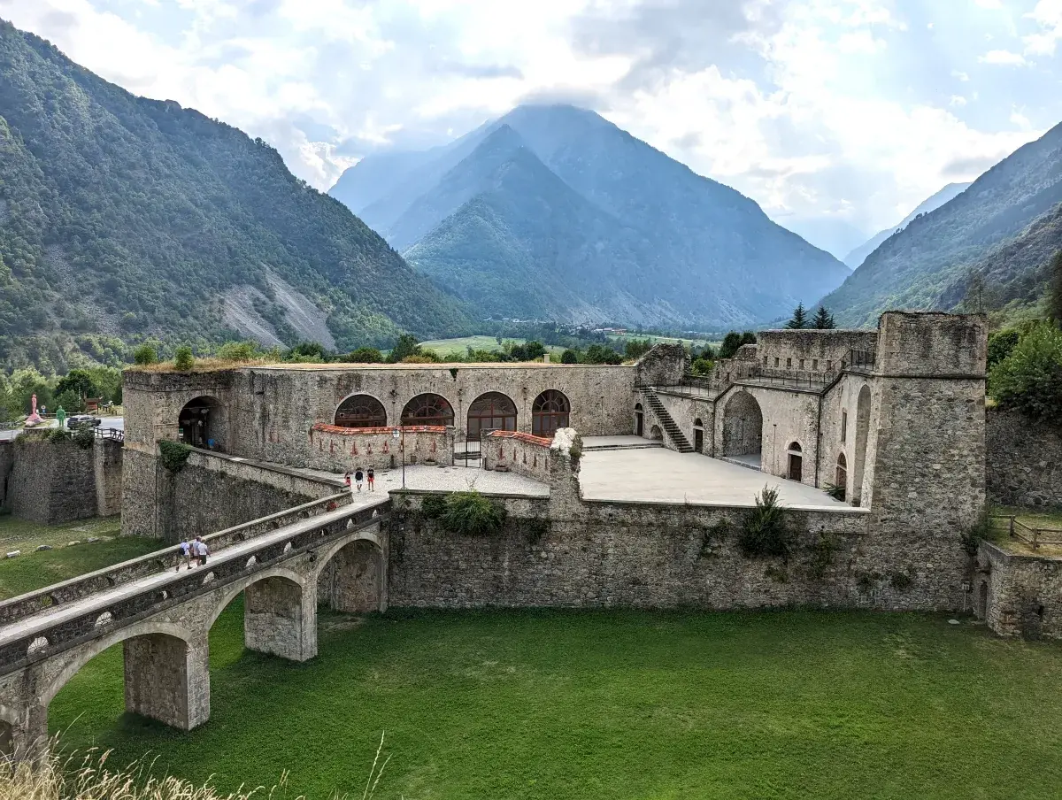 Ancient fortress amidst mountains, a scenic spot for day trips from Turin.