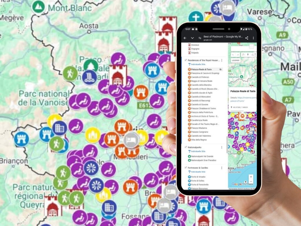 A hand holding a smartphone displaying a custom Google My Maps interface titled "Best of Piedmont Map," featuring a list of historical sites, castles, national parks, and points of interest in the Piedmont region of Italy. The background consists of a zoomed-in section of the same map, showing a dense cluster of colorful icons representing different categories, including hiking trails, cultural landmarks, and fortresses. The smartphone screen highlights a selection of castles, including "Palazzo Reale di Torino," with its coordinates and details visible.