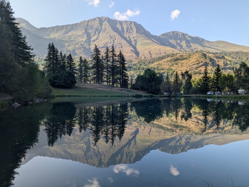 When deciding how many days to spend in Piedmont Italy, Lago di Laux is worth adding for its peaceful Alpine setting, with rugged mountain peaks and pine forests mirrored in the clear lake.